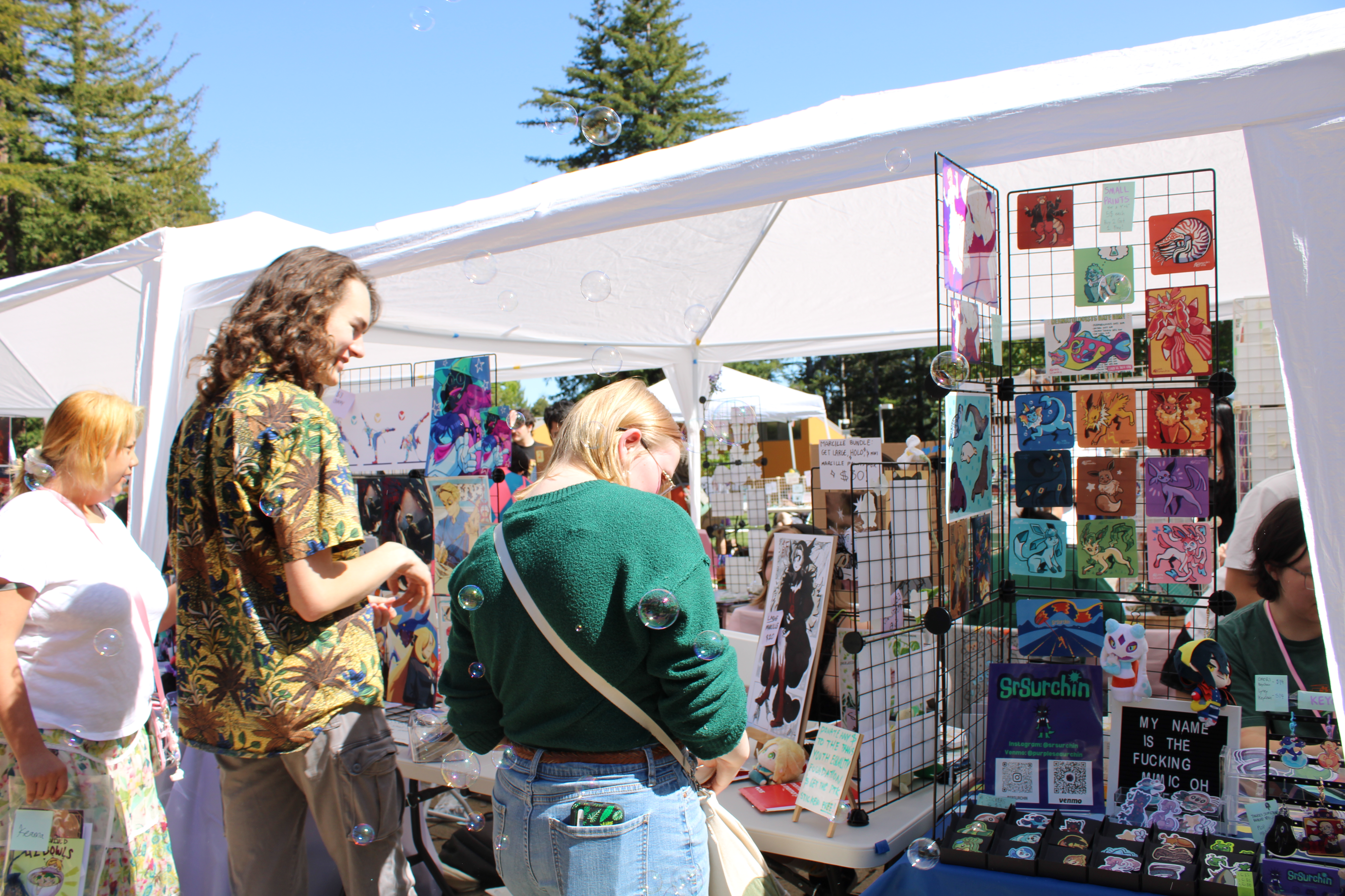 shot of two people shopping at an artist's booth